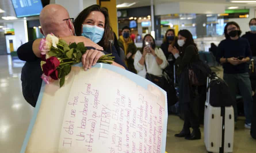 People applaud and take pictures as MaKensi Kastl greets her boyfriend, Thierry Coudassot, after he arrived from France at Newark airport in New Jersey on Monday (AP Photo/Seth Wenig)