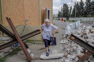 Bakhmut, Ukraine: an elderly woman makes her way through rubbles near a market
