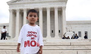 A boy wears a T-shirt reading ‘Don’t deport my mom.