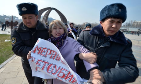 A protestor in Kyrgyzstan is arrested.