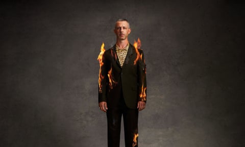 Jeremy strong wearing a suit that appears to be on fire