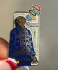A pin badge of Snoop Dogg blowing smoke in the shape of the Olympic rings