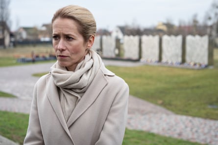 Kaja Kallas speaks to the press in Bucha in front of the devastated town’s memorial.