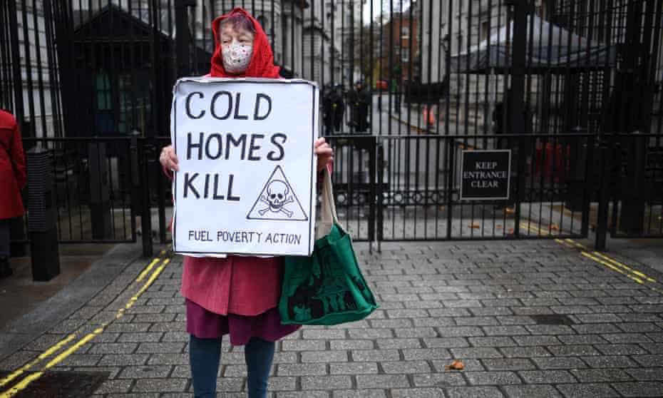 A protester highlights excess winter deaths caused by fuel poverty, outside Downing Street in November 2021.