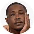Danez Smith, a person posing with hand resting on face in portrait