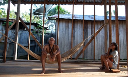Daman Matis sits in a hammock under the roofed framework of a building.