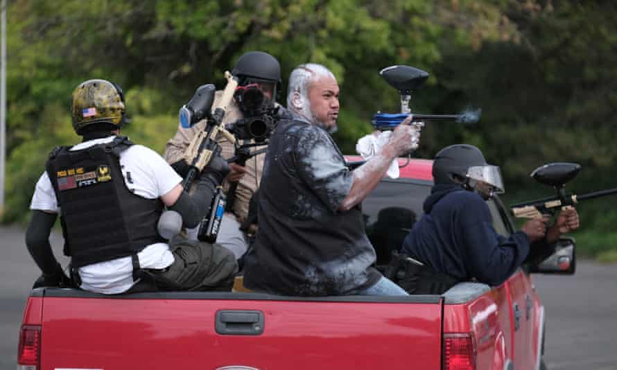 Tusitala ‘Tiny’ Toese, a member of the far-right group Proud Boys, fires paintball rounds at anti-fascist protesters as they depart from their rally on Sunday in Portland.