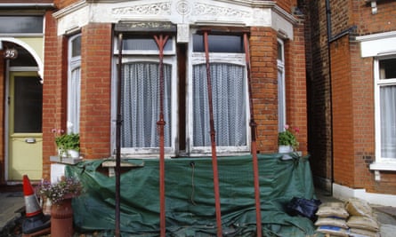 Edwardian terrace house brick bay being held up by props due to subsidence