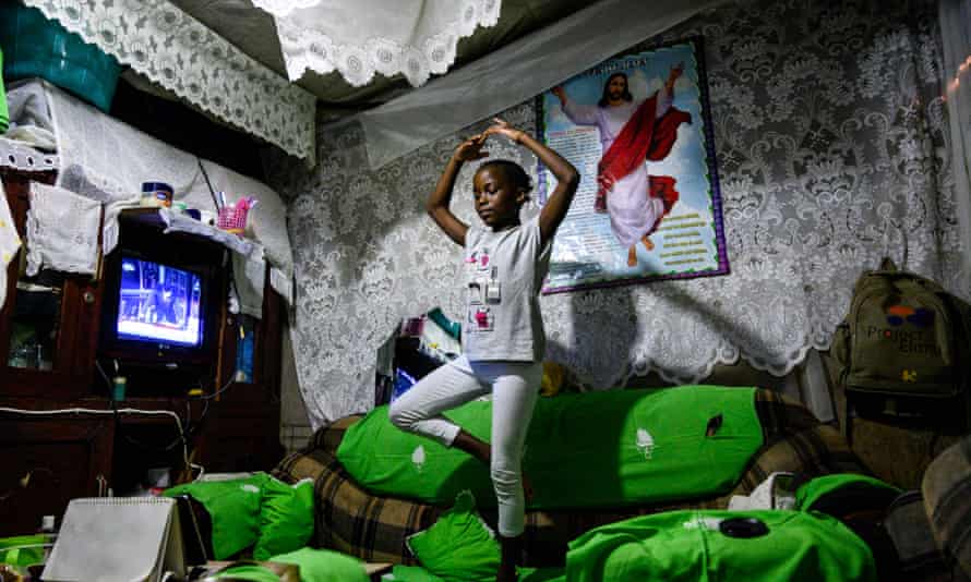 Lydia Akoth, 10, has a dance lesson by mobile phone at home in the Kibera slum, Kenya. Girls are in more danger of giving up on education after lockdown.
