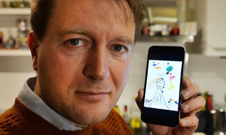 Richard Ratcliffe holds his phone with a drawing by his daughter Gabriella.