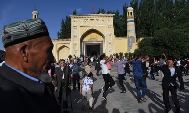  Uighur men dancing after Eid al-Fitr prayers, marking the end of Ramadan, outside the Id Kah mosque in Kashgar, in China’s western Xinjiang region