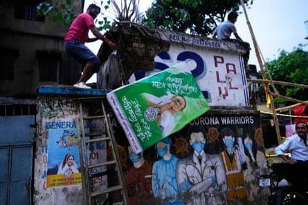 A man takes down an election poster