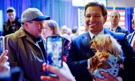 Ron DeSantis poses for pictures in Des Moines, Iowa, on 10 March.