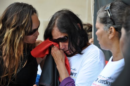 The mother of 22-year-old Yamatji woman Ms Dhu, who died in police custody in Port Hedland after being arrested over unpaid fines, is comforted by family outside the coronial inquest.