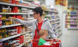 Young mother with a baby in a supermarket