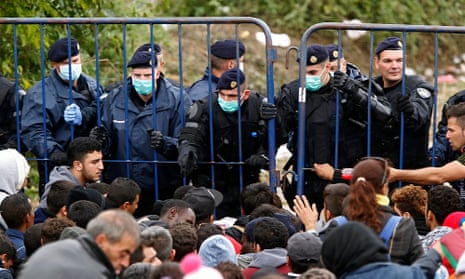 Croatian border police face refugees at the border with Serbia.