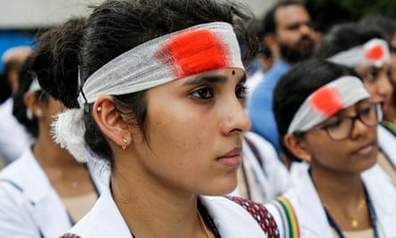 Medical students wear mock bandages during a protest in Kochi