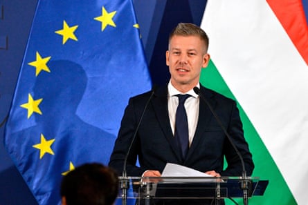 Péter Magyar speaking in front of EU and Hungarian flags.