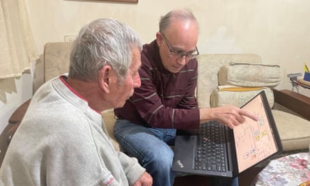 Shalom Koray con Daniel Horowitz, mostrándole algo en una computadora portátil
