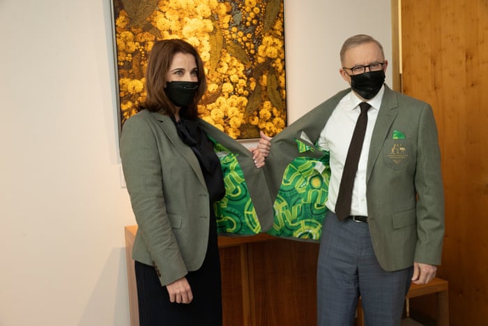 Minister for Aged Care and Sport Anika Wells presents Prime Minister Anthony Albanese with an Australian team commonwealth games blazer in his office