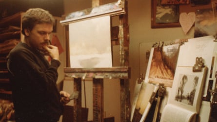 A still of a man looking at paintings
