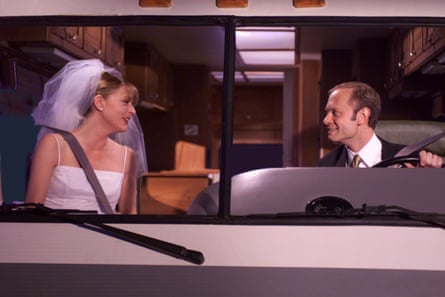 Niles and Daphne, in their wedding outfits, escaping in a camper van