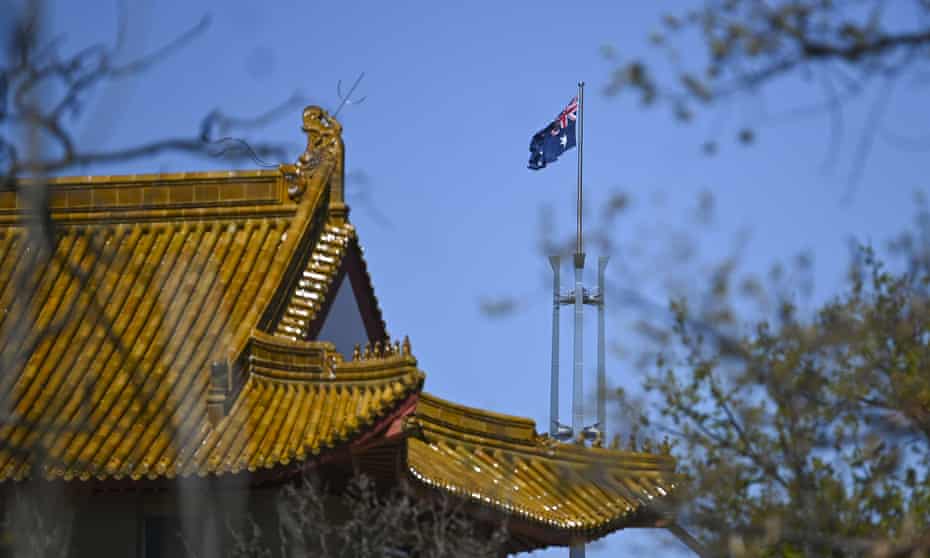 The flagpole of the Australian Parliament is seen behind the roof of the Chinese Embassy in Canberra