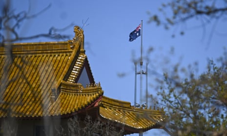 The flagpole of the Australian Parliament is seen behind the roof of the Chinese Embassy in Canberra