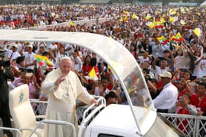 Pope Francis waves to the crowd during a public mass on 29 November in Yangon