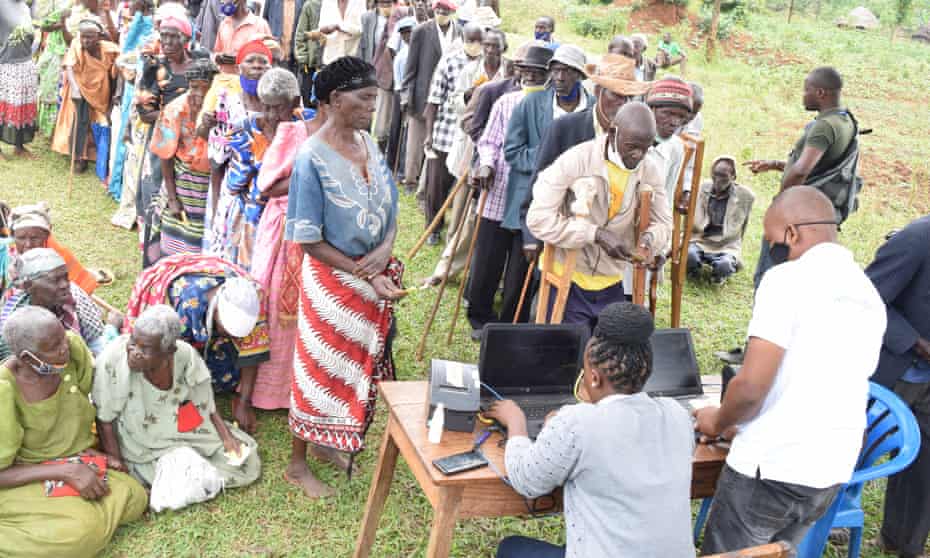 Elderly people wait to validate their identity cards