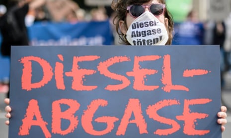 A protester wears a mask and a placard reading ‘diesel emissions kill’ in front of the German transport ministry in Berlin.
