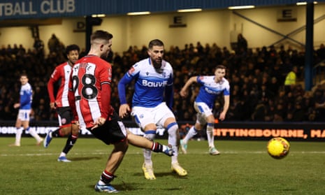 Sheffield United’s James McAtee sidefoots in the Blades’ third.