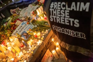 A “reclaim these Streets” poster, a resistance movement aiming for community ownership of public spaces is seen at the vigil.
