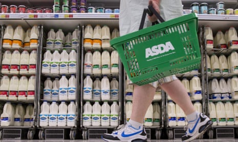a shopper passes the milk aisle at asda