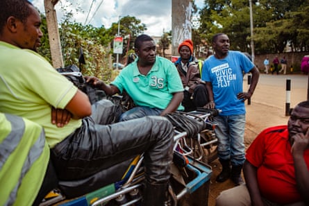 Fred Juma waits for business with fellow boda boda drivers in Nairobi