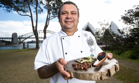 Indigenous chef Clayton Donovan poses with native bush tomatoes, lemon myrtle leaves and pepper berries