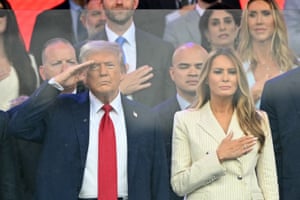 a man salutes while a woman holds her hand over her heart