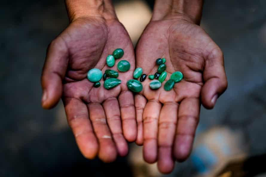A jade trader in Myanmar’s Kachin state displays a selection of stones for sale
