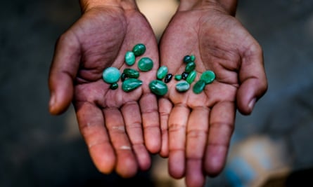 MYITKYINA, MYANMAR - MARCH 13th, 2016: A jade trader displays a selection of his stones for sale.