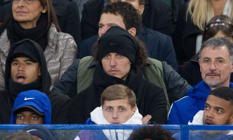 Chelsea’s David Luiz, centre, watches Sunday’s match against Manchester United from the stands after being dropped from the squad by his manager, Antonio Conte.