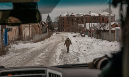 A soldier walks through the snowy streets of then occupied Kupiansk in February 2022.