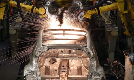 Robotic arms assemble and weld the body shell of a Nissan car on the production line at Nissan's Sunderland plant