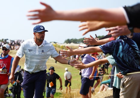 Bryson DeChambeau high fives the crowd