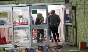 Looters ransack an Office Depot store during protests on Friday night in Minneapolis.
