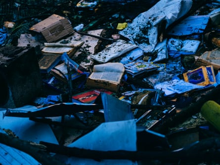 Open books amid debris strewn across the ground