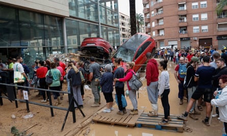 People queueing in flood damaged Paiporta in Valencia province