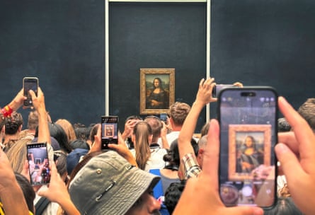 Global pulling power … visitors viewing the Mona Lisa in the Louvre.