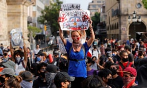 A protester holds up a sign in Guadalajara, Jalisco, during a rally on Saturday.