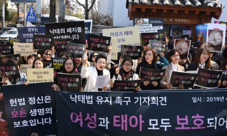 Anti-abortion activists shout slogans in front of the court in Seoul