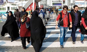 Iranians cross a street in Tehran